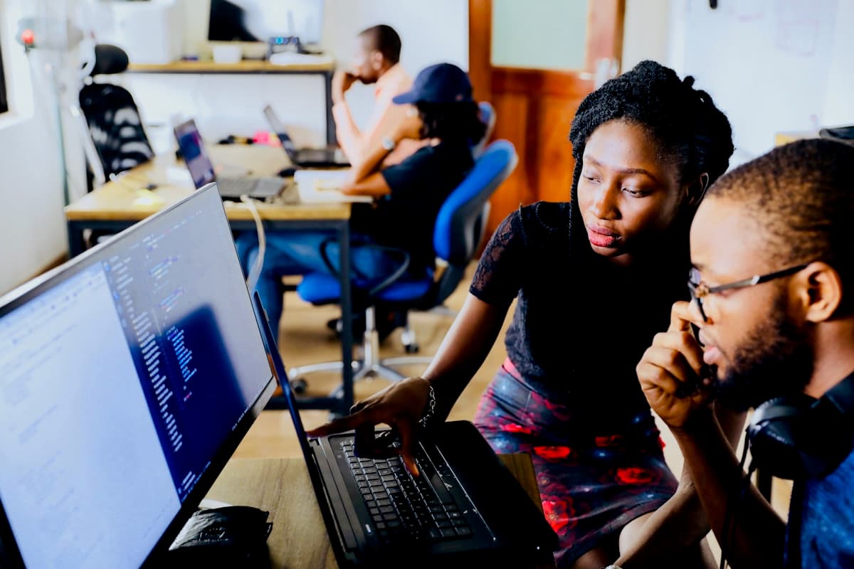 Two Spider IT Solutions engineers reviewing code together