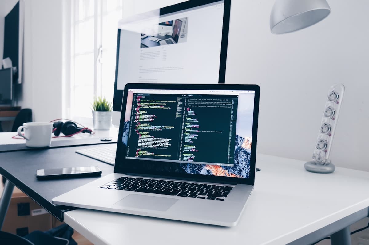 A developer workspace with code open on a laptop